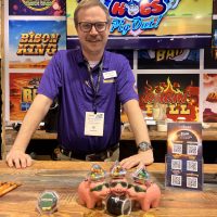 Eclipse employee with a big smile greeting customers at the IGA trade show 2024.